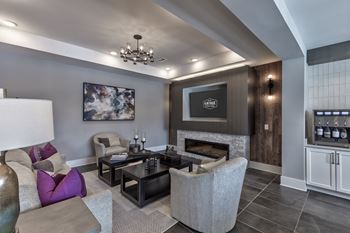 a living room with couches and chairs and a fireplace